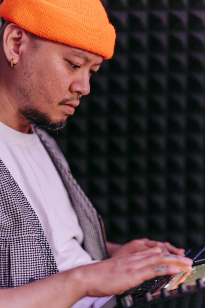 Music producer deeply engaged with a digital sequencer, showcasing creativity in a modern recording studio.